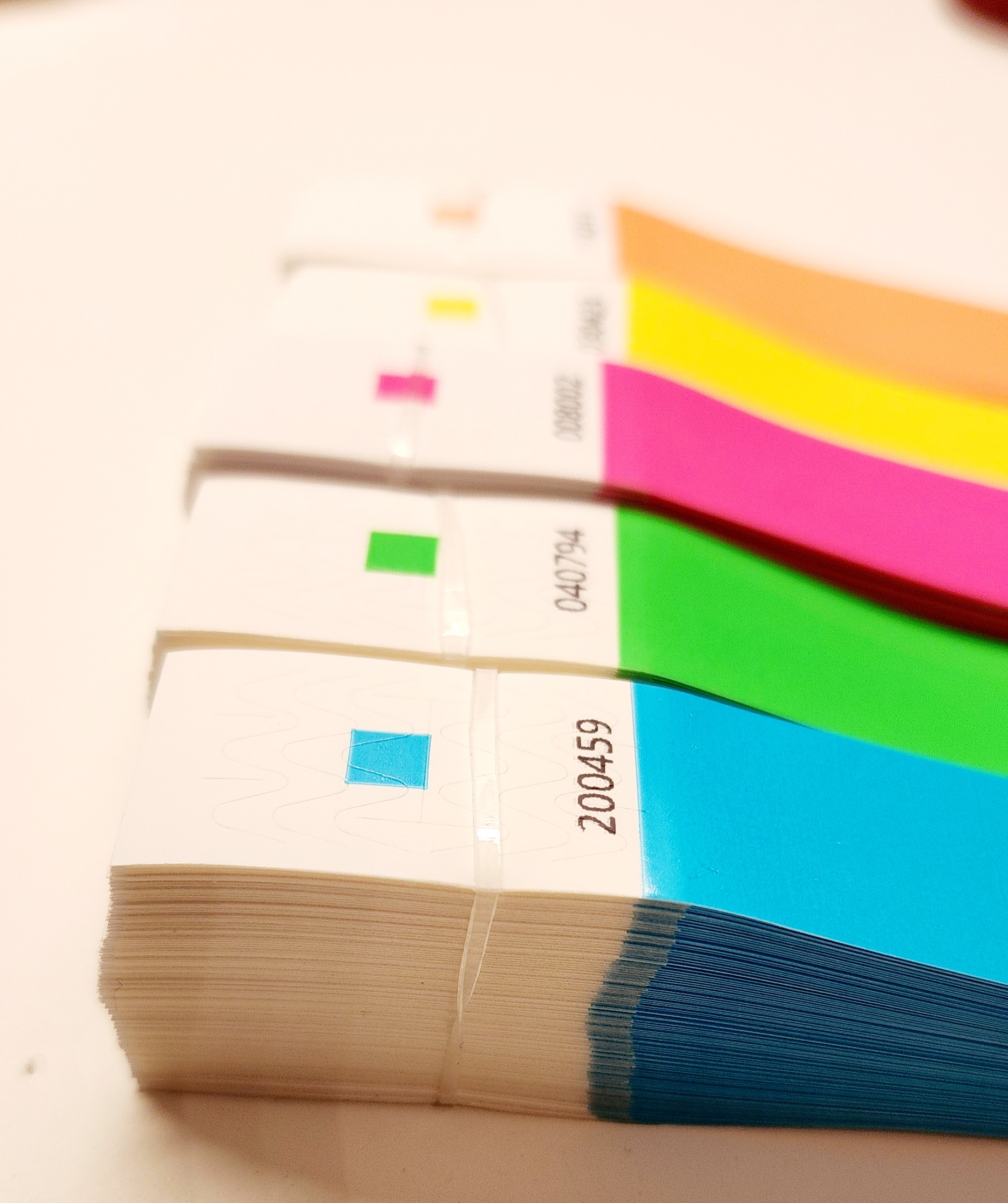 Stacks of colourful Tyvek wristbands